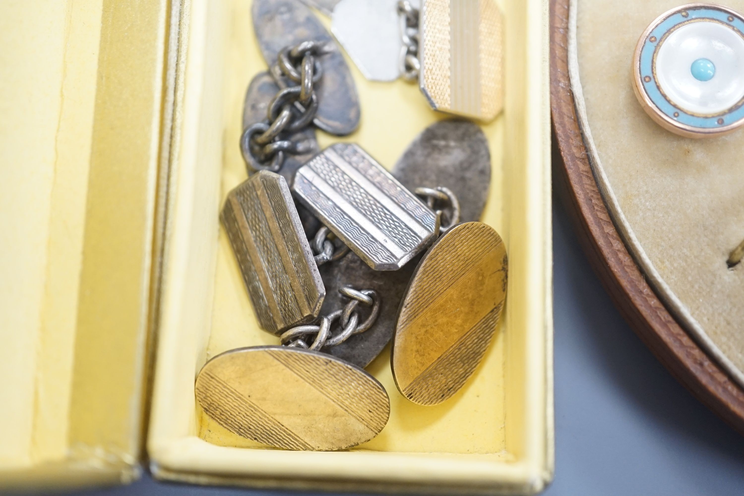 A cased early 20th century six piece gilt metal, mother of pearl and enamel dress stud set and four pairs of silver or white metal cufflinks.